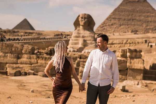 Happy couple and Pyramid, Cairo, Egypt. Tourists having fun in G