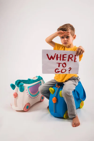 Een Mooie Kleine Jongen Zit Een Zak Een Witte Studio — Stockfoto