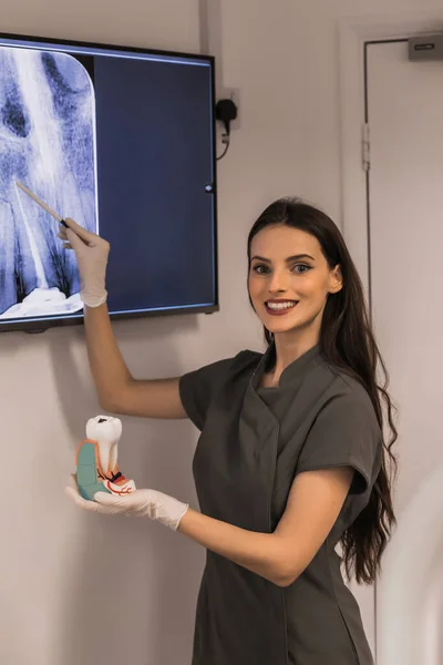 Doctor points to filled root canal in dental x-ray