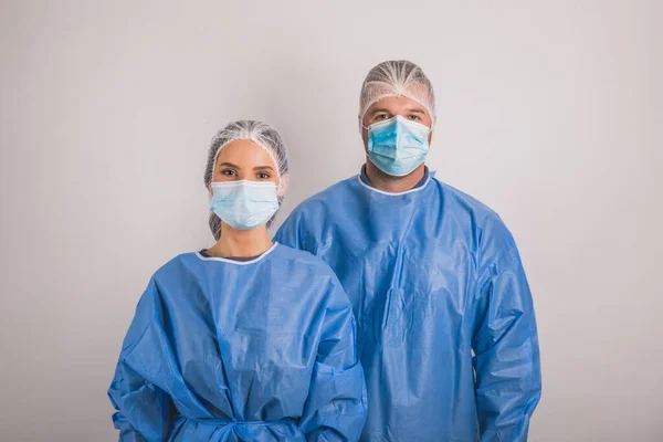 doctors man and woman on a white background in medical masks on