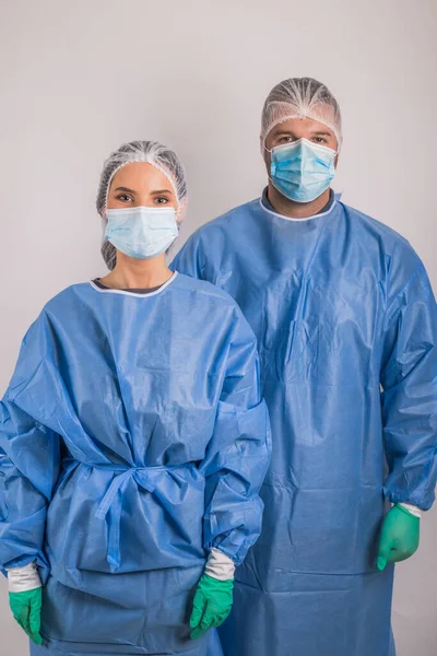 doctors man and woman on a white background in medical masks on