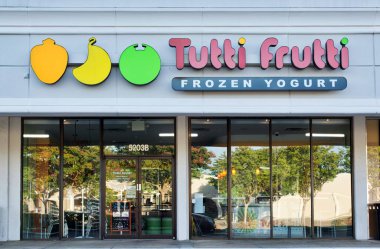 Houston, Texas USA 07-15-2022: Tutti Frutti frozen yogurt storefront and building exterior in Houston, TX. Self-serve retail chain founded in 2008.