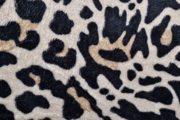 Leopard skin pattern on a blanket with black and white colors, safari theme. Fabric swatch patterned sample viewpoint from directly above.