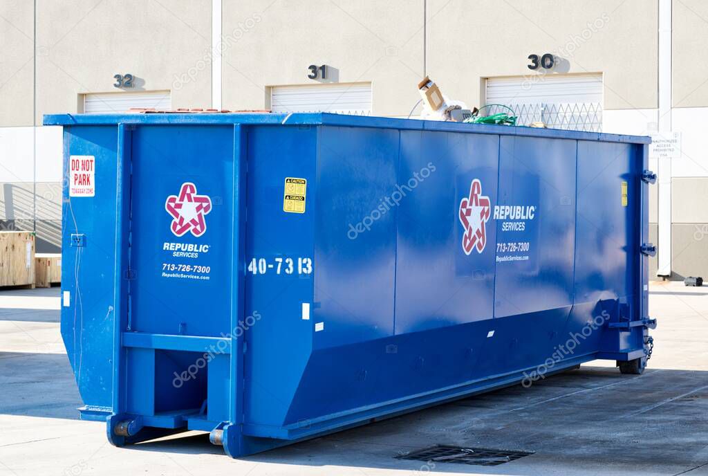 Houston, Texas USA 09-18-2022: Republic Services waste management solid trash dumpster bin in a warehouse yard.