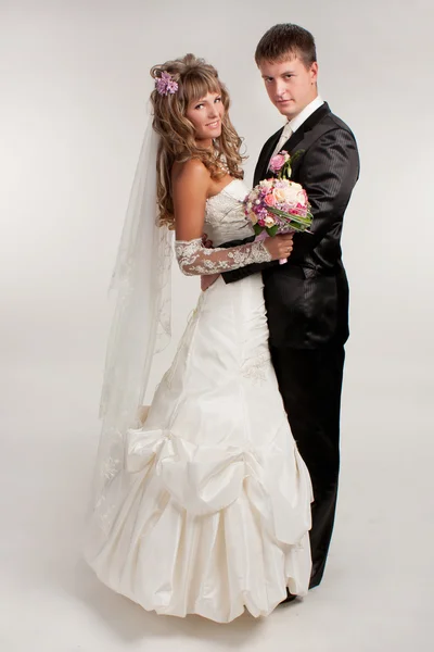 Happy newlyweds in studio — Stock Photo, Image