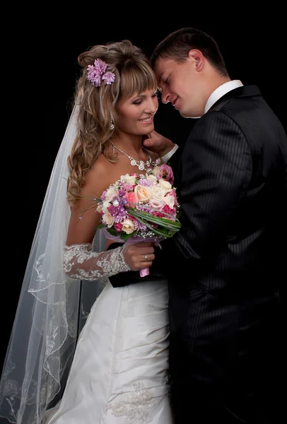 Happy newlyweds in studio — Stock Photo, Image