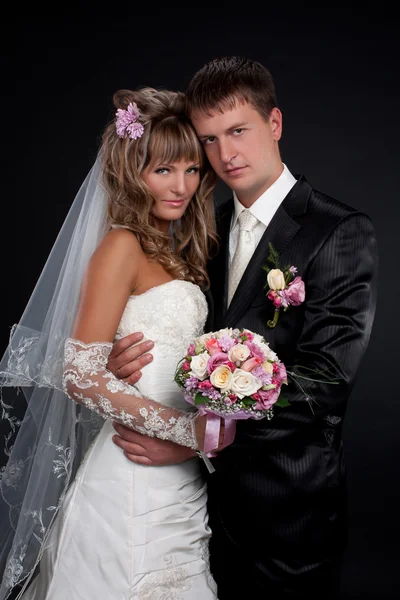 Happy newlyweds in studio — Stock Photo, Image