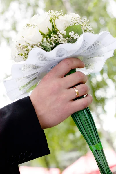 Wedding bouquet at groom's hands — Stock Photo, Image