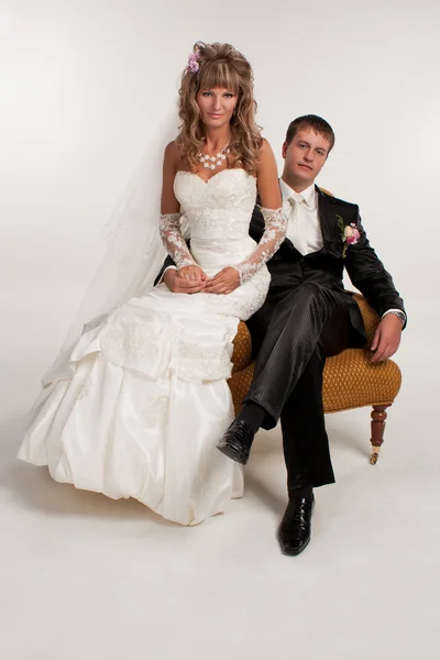 Happy newlyweds in studio — Stock Photo, Image