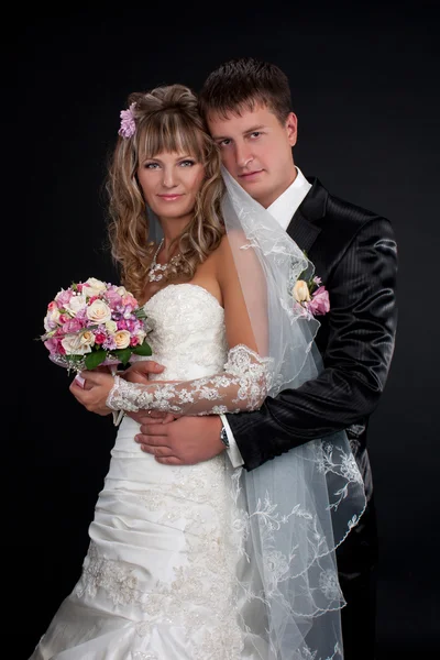 Happy newlyweds in studio — Stock Photo, Image