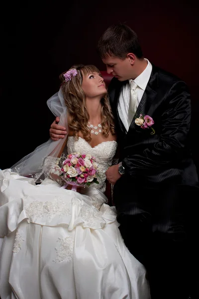 Happy newlyweds in studio — Stock Photo, Image