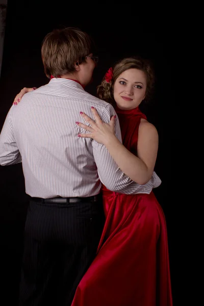 Young couple in red dancing tango — Stock Photo, Image