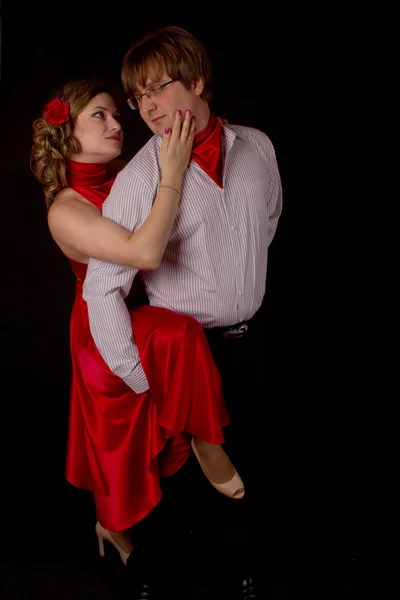 Young couple in red dancing tango — Stock Photo, Image