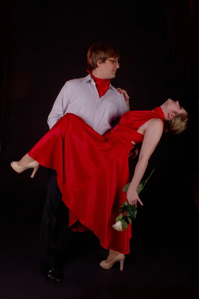 Young couple in red dancing tango Royalty Free Stock Photos