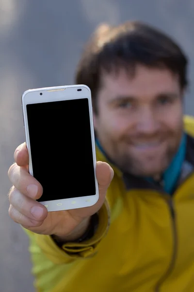 Muž s plnovousem a mobilní telefon — Stock fotografie