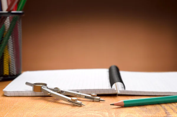 Notebook, pencils and compass — Stock Photo, Image