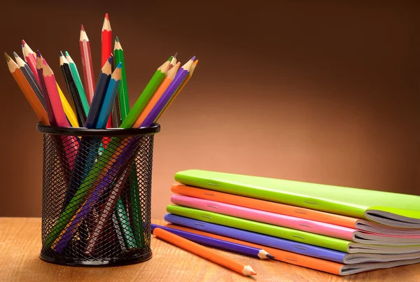 Set of pencils and notebooks — Stock Photo, Image