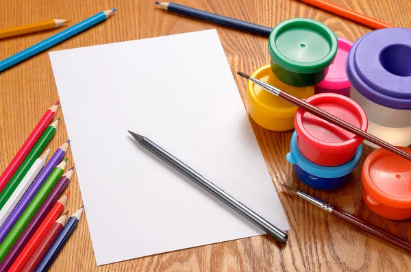 Blank sheet of paper with colorful pencils and paints — Stock Photo, Image