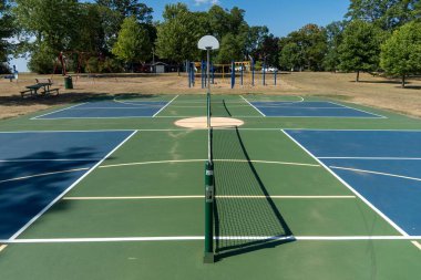 Empty Pickleball court blue and green recreational sport at an outdoor park.