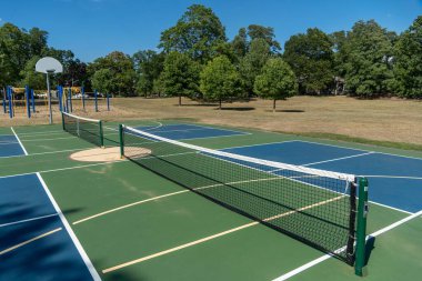 Empty Pickleball court blue and green recreational sport at an outdoor park.