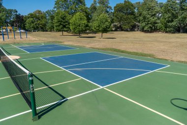 Empty Pickleball court blue and green recreational sport at an outdoor park.