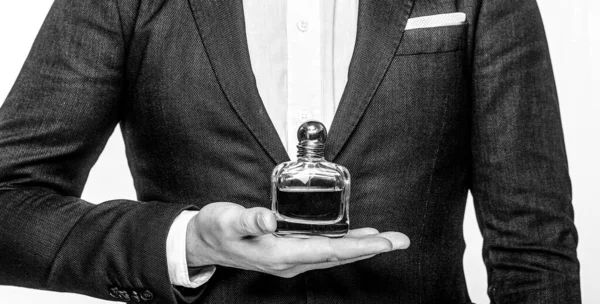 Perfume or cologne bottle and perfumery, cosmetics, scent cologne bottle, male holding cologne. Masculine perfume. Male holding up bottle of perfume. Man perfume, fragrance — Stock Photo, Image