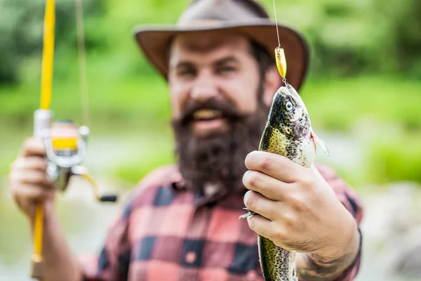 Fishing. Angler with fishing trophy. Fisherman and trout. Fishing backgrounds. Man hold big fish trout in his hands. Fisherman and trophy trout. Man holding a trout fish — Stock Photo, Image