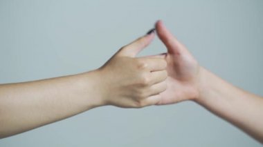 Human arm and thumb wrestling. Woman and man hands playing thumb wars closeup, arm gestures concept. Two hands show gestures, fight with fingers, move. Close up