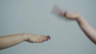 Friendship, dealing with conflict, having fun. Hanging out. Rock paper scissors being played by two young man. Close up view of female and male hands playing stone, scissors and paper
