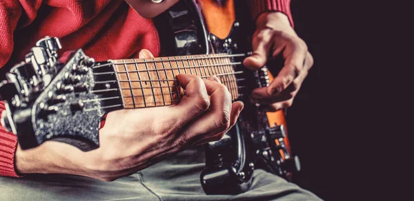 Man playing guitar. Close up hand playing guitar. Musician playing guitar, live music.