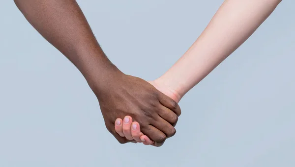 Black and white hand Love Partnership. Black, White Woman and man Holding Hands Together.