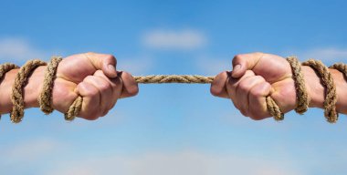 Rope, cord. Hand holding a rope, climbing rope, strength and determination. Rescue, help, helping gesture or hands. Conflict tug of war. Two hands, helping hand, arm, friendship.