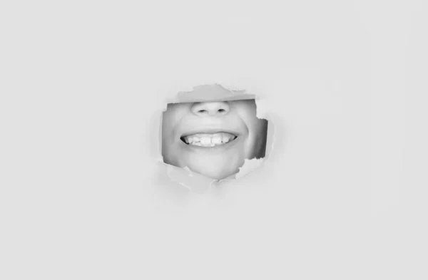 Breaking Paper Background Emotions Concept Kid Toothy Smile Shows Face — Zdjęcie stockowe