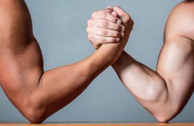 Rivalry, closeup of male arm wrestling. Two hands. Muscular men measuring forces, arms. Hand wrestling, compete. Hands or arms of man.