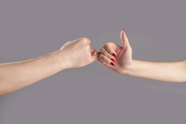 Hand to pinky swear,Happy couple or friendship holding hands together forever. Finger two hands hold together. Show friendship and forgiveness. Man and woman do Pinky promise or pinky swear hands.