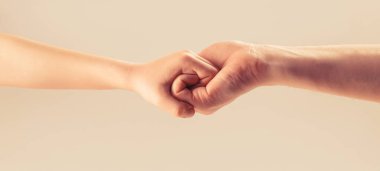 Friendly handshake, friends greeting. Rescue, helping hand. Man help hands, protection. Woman and kid hands connect with each other. Male and child hands connected each other together and forever.