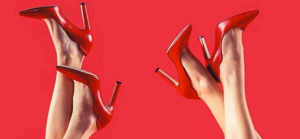 Pretty female legs with red high heels on red background. Perfect female legs wearing high heels. Shapely legs, a girl in shoes high-heeled.
