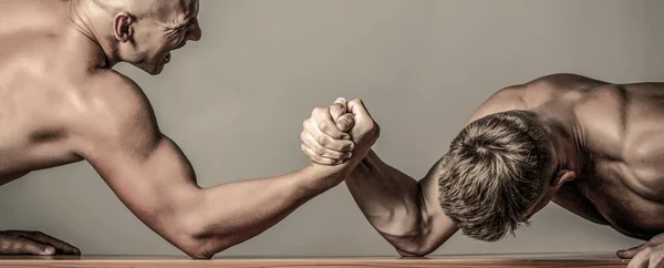Hands or arms of man. Arm wrestling. Two men arm wrestling. Rivalry, closeup of male arm wrestling.