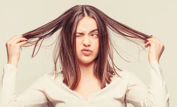 Bad hairs day. Frustrated woman having a bad hair. Woman having a bad hair, her hair is messy and tangled.