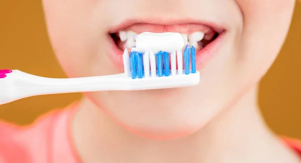Dental hygiene. Happy little kid brushing her teeth. Health care, dental hygiene. Kid boy brushing teeth. Boy toothbrush white toothpaste. Joyful child shows toothbrushes. Little boy cleaning teeth.