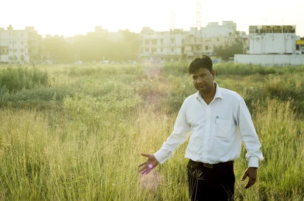 Farmer or businessman touching grass — Stock Photo, Image