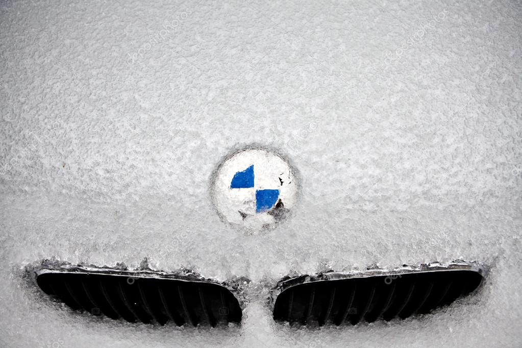 Bucharest, Romania - February 5, 2012: Picture of the BMW logo covered with ice. Founded in 1917, Bayerische Motoren Werke AG is a German automobile, motorcycle and engine manufacturing company.