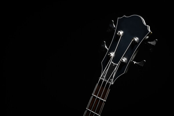 Head stock of a dark electrical bass guitar