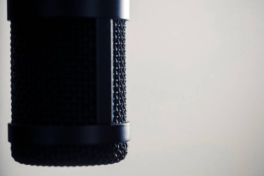 Siyah bir mikrofonun yakın çekim görüntüsü, sağ tarafında kopyalama alanı var..