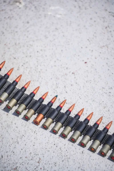 Close up shot of a machine gun belt loaded with cartridges.