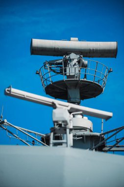 Image of  a military radar air surveillance on navy ship tower.