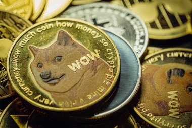 Close up shot of a golden Dogecoin cryptocurrency in a stack, among other various digital cryptocurrencies .
