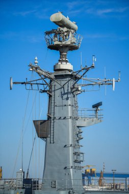 Image of  a military radar air surveillance on navy ship tower.