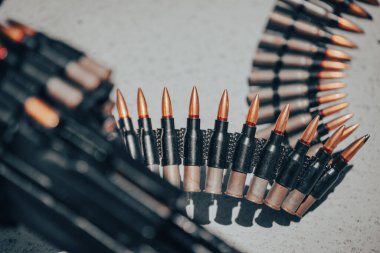 Close up shot of a machine gun belt loaded with cartridges.