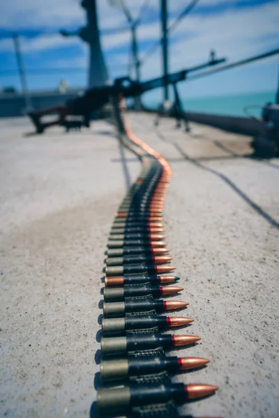 Close up shot of a machine gun belt loaded with cartridges.